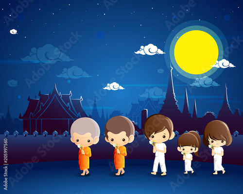 Buddhist walking with lighted candles in hand around a temple to pay respect.