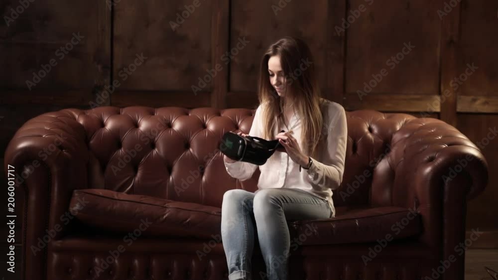 Blonde in virtual reality glasses in the loft, plays a BP game. Very emotional active girl, her impression is what she sees in the game, Ready player one