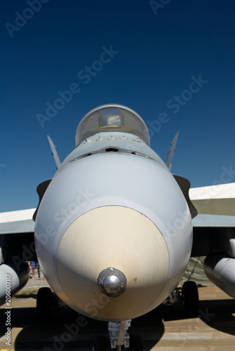 Nose of a jet fighter at an air show against a blue sky