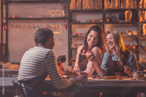 Smiling people at work in pottery