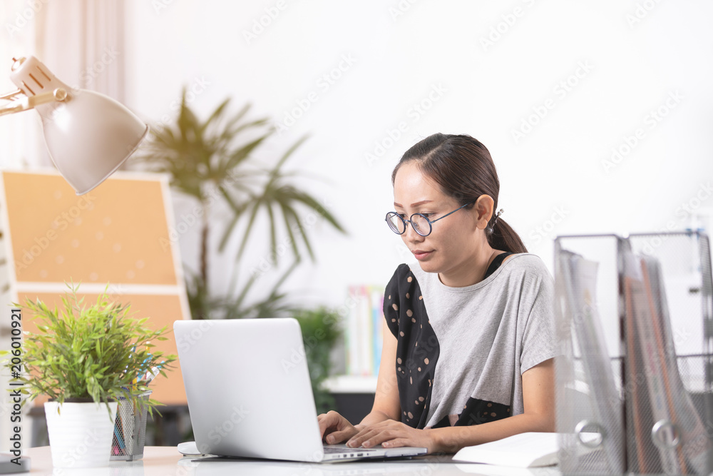 Business asian woman Sad and worried working with a laptop in an office, Business asian woman Sad and worried working with a laptop in an office,