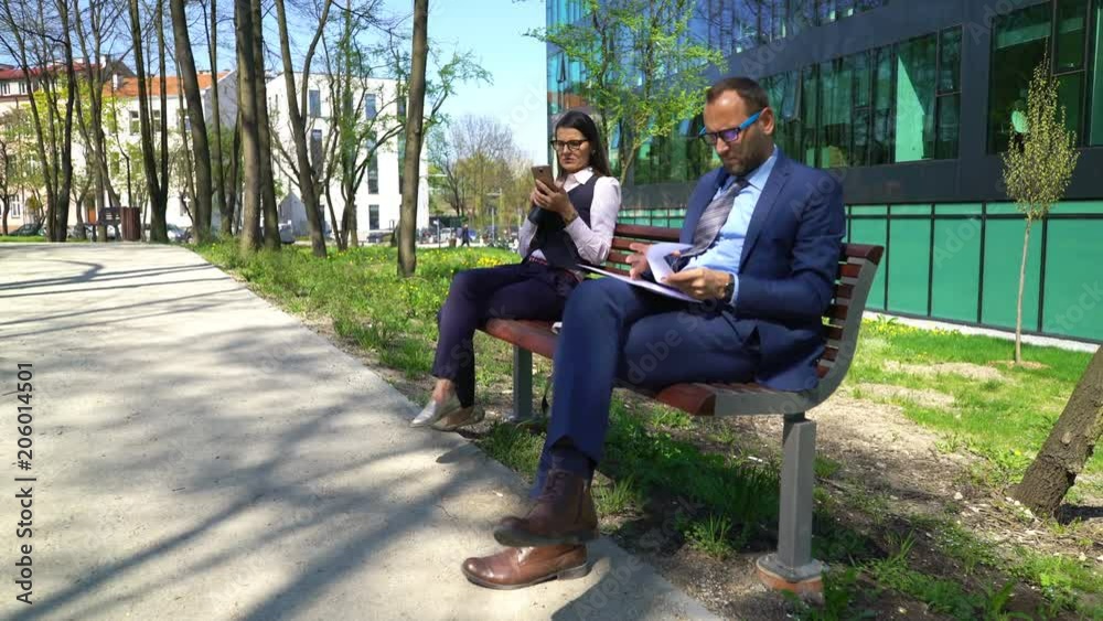 custom made wallpaper toronto digitalYoung businessman and businesswoman with smartphone and documents in the city