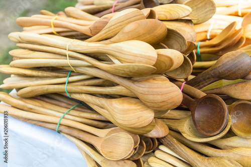 Lot of wooden spoons on street farm market