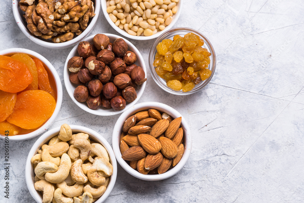 Nuts and dried fruits assortment on stone table top view. Nuts and dried fruits assortment on stone table top view.