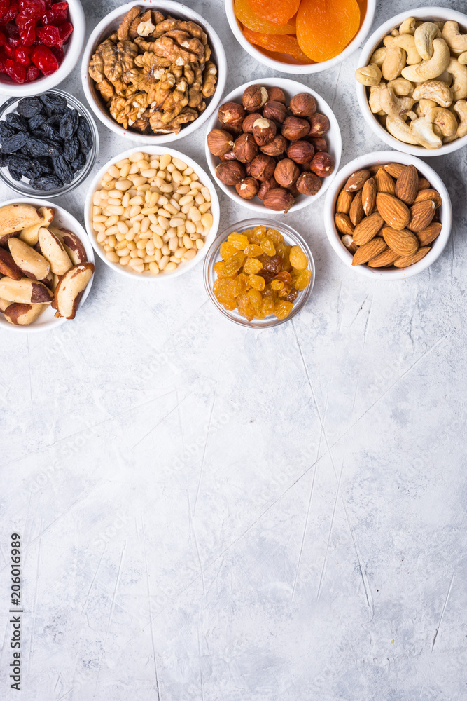 Nuts and dried fruits assortment on stone table top view. Nuts and dried fruits assortment on stone table top view.