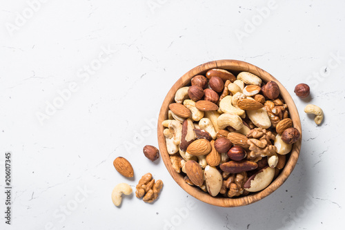 Nuts assortment in a bowl on white top view.