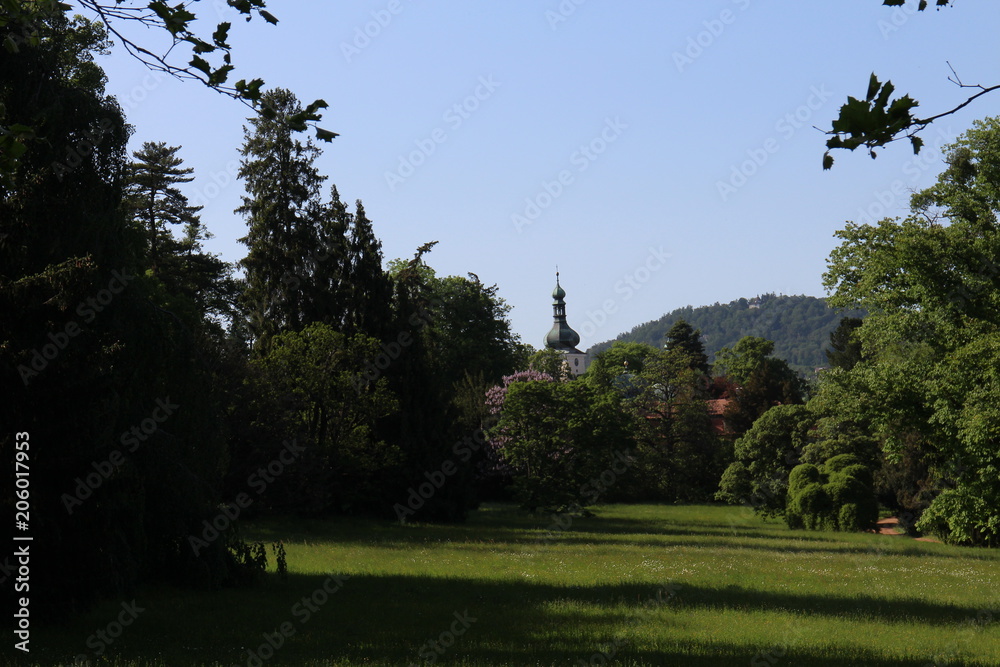 Garden of Buchlovice castle with church tower, Czech republic