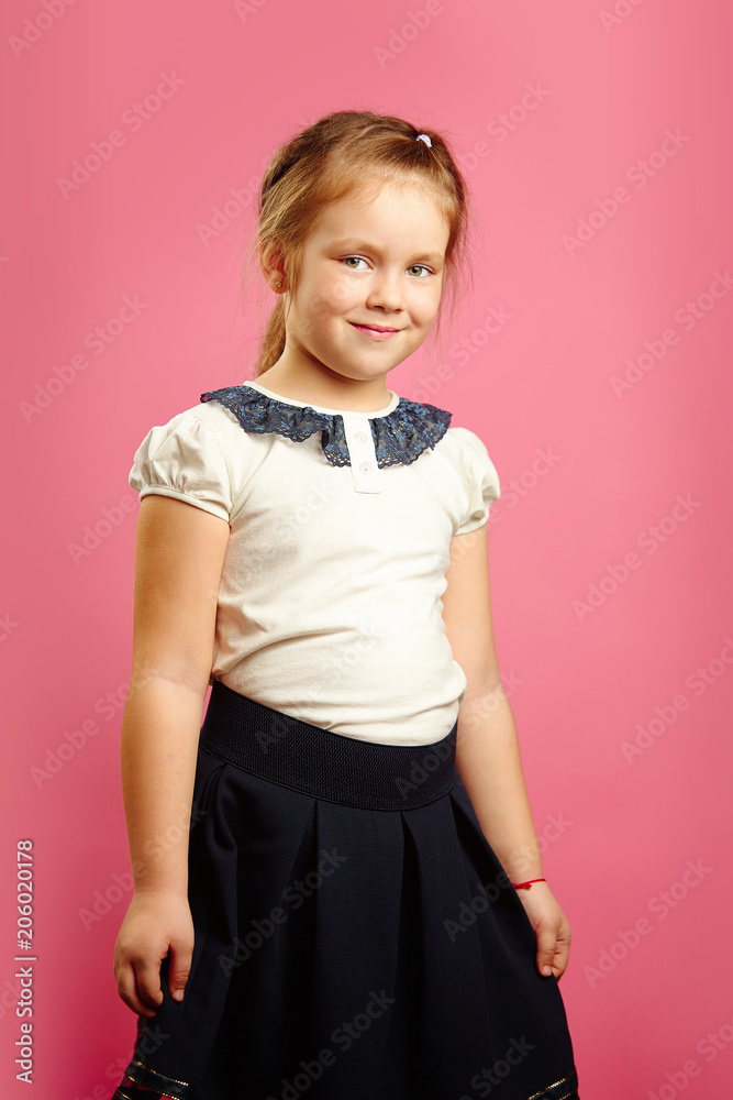 Portrait of cute child girl in white t-shirt and black skirt. Portrait of cute child girl in white t-shirt and black skirt.