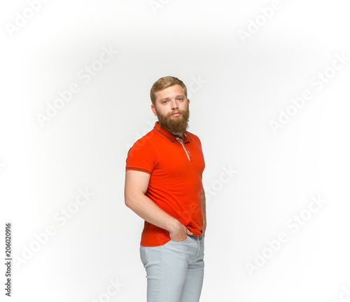 Closeup of young man's body in empty red t-shirt isolated on white background. Mock up for disign concept