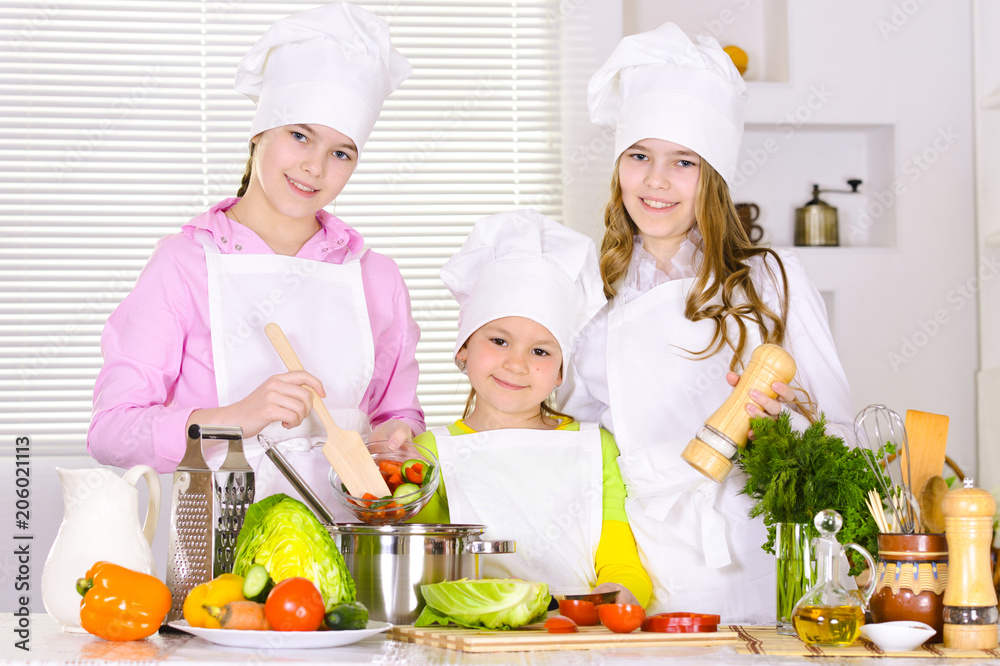 happy cute girls cooking vegetable dish happy cute girls cooking vegetable dish