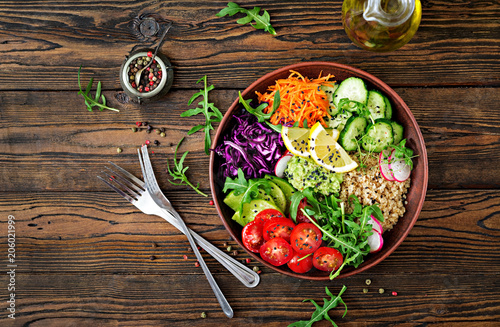 Vegetarian Buddha bowl with quinoa and fresh vegetables. Healthy food concept. Vegan salad. Top view. Flat lay photo