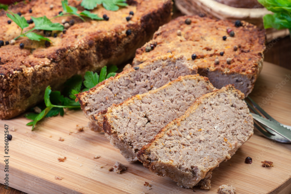 Traditional delicious meat pate with chicken liver on cutting board Traditional delicious meat pate with chicken liver on cutting board