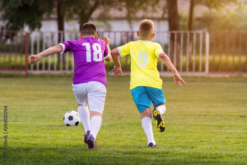 Young children players football match on soccer field Young children players football match on soccer field