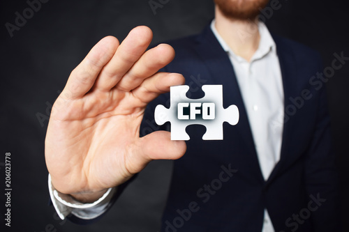 Businessman holding a puzzle with the inscription:CFO