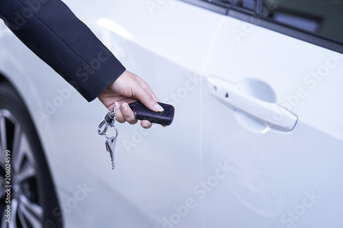 Businessman opens car door with remote.