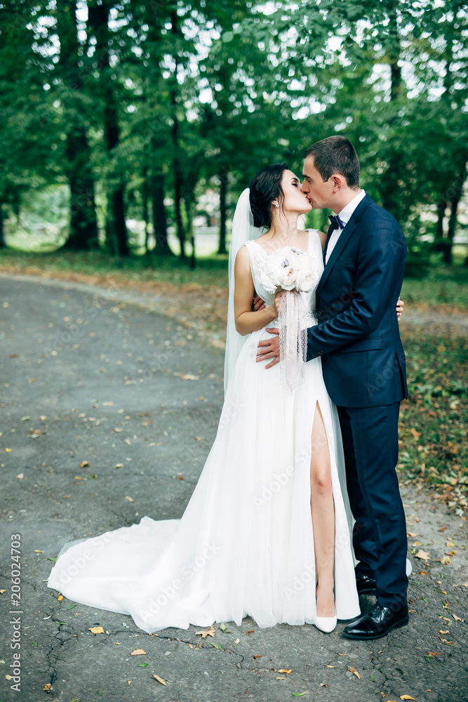 Bride and groom in a morning light in park. Wedding day Bride and groom in a morning light in park. Wedding day