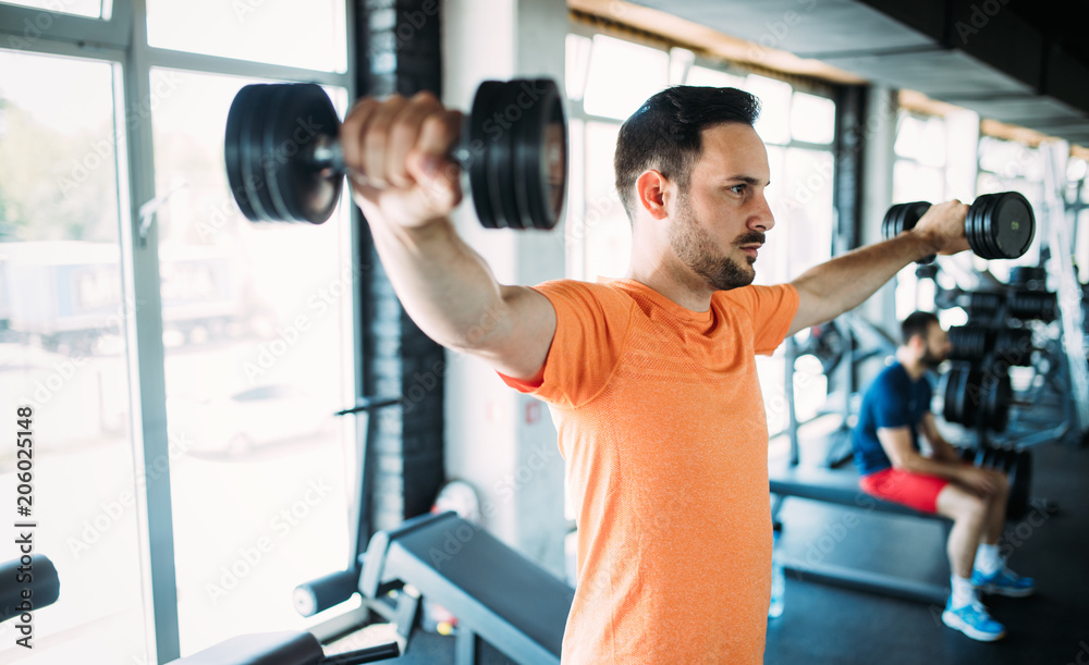 Determined male exercising in gym Determined male exercising in gym