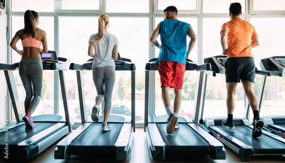 Group of friends exercising on treadmill machine Group of friends exercising on treadmill machine
