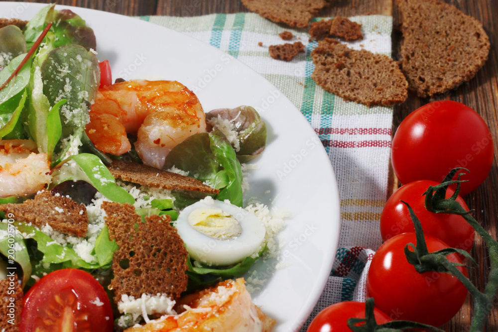 Caesar salad with shrimps on textile background Caesar salad with shrimps on textile background