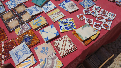 Street flea market of old things and antiques. Stand with vintage Portuguese tiles.