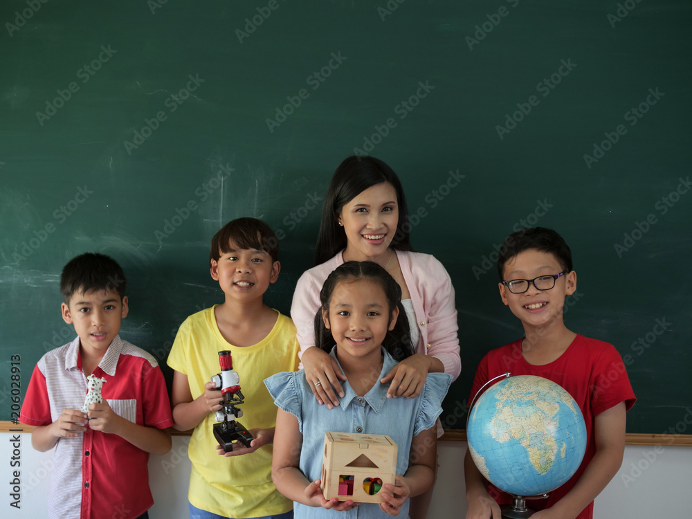 Student group with teacher standing over chalkborad,copy space. Student group with teacher standing over chalkborad,copy space.