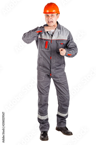 Full length portrait of a male builder in a helmet looking at camera over white wall background. repair, construction, building, people and maintenance concept.