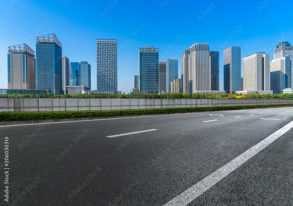 Empty urban road and modern skyline. Empty urban road and modern skyline.