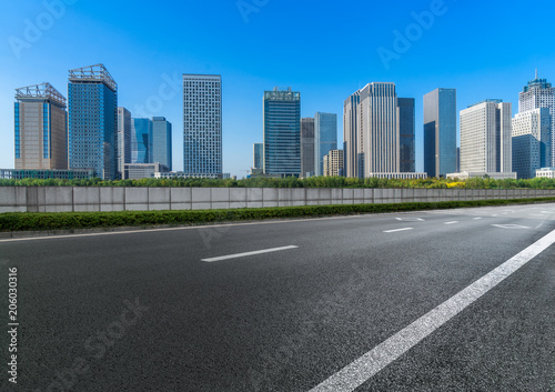 Empty urban road and modern skyline.