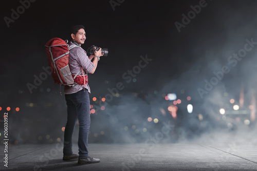 Handsome asian traveler with backpack and camera © Leo Lintang