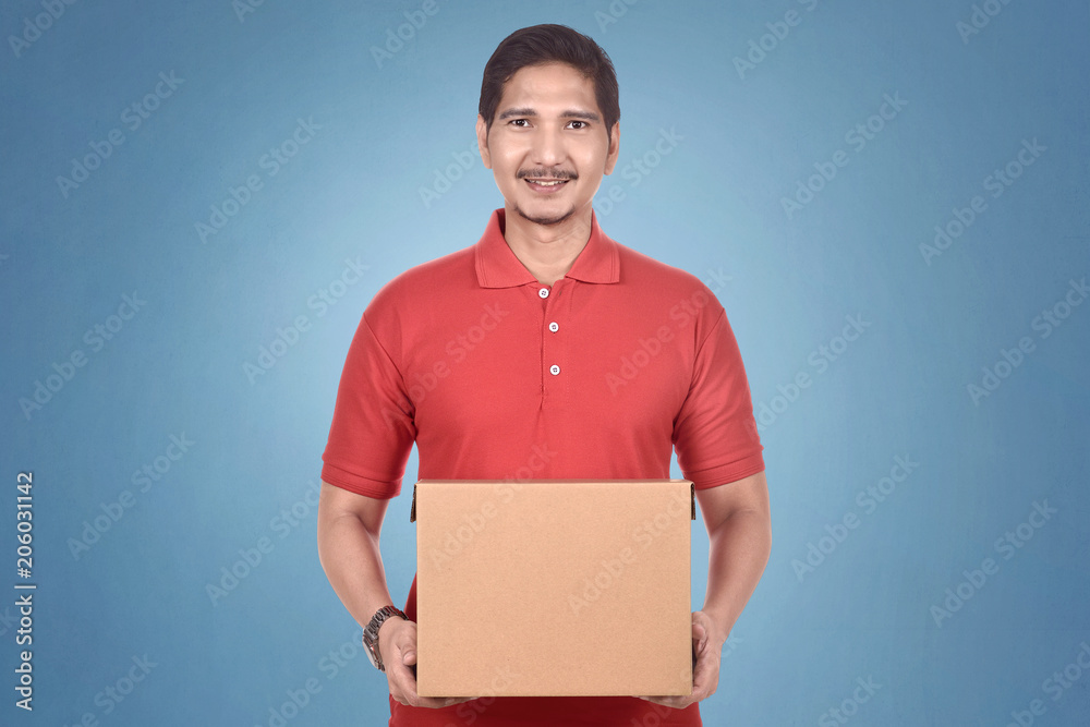 Attractive asian courier man holding package Attractive asian courier man holding package