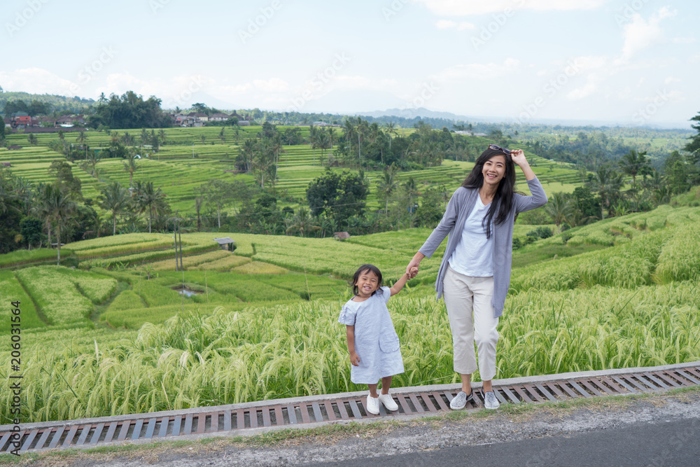 mother and daughter enjoy paddy rice field view