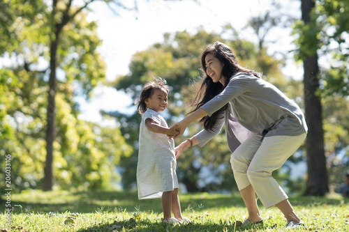 Mother and daughter playing in the park