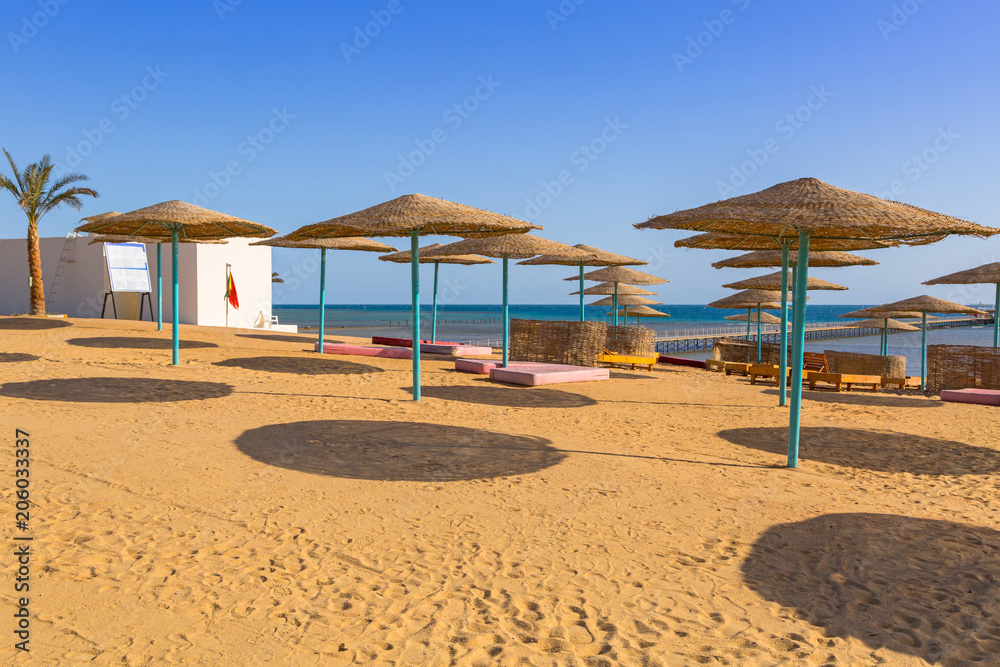 Fototapeta premium Parasols on the beach of Red Sea in Hurghada, Egypt