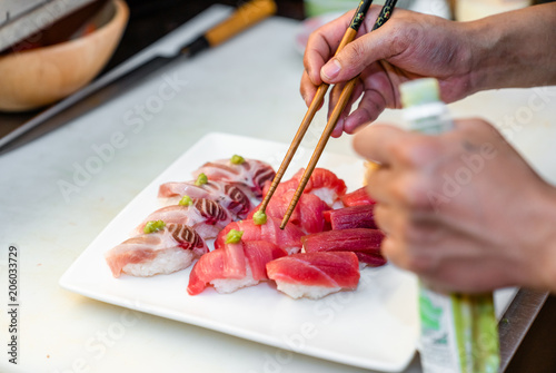 Japanese chef arrange sushi on the plate 