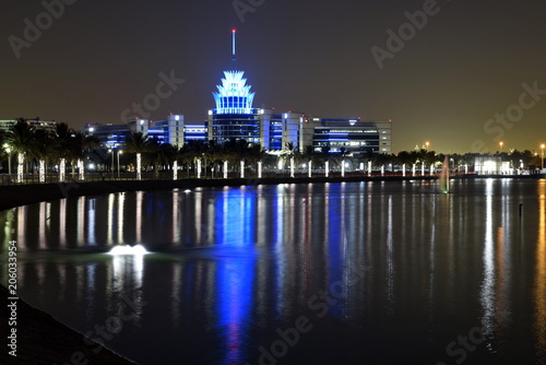 Photography Dubai, United Arab Emirates - May 21, 2018: Dubai Silicon Oasis Headquarters Building with Lake view at night, Established in 2014 a free zone owned by the Government of Dubai