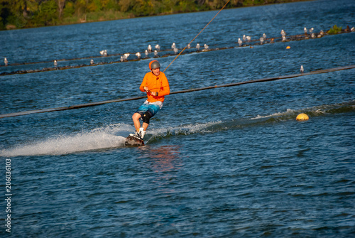 Wakeboarder makes a turn while training photo