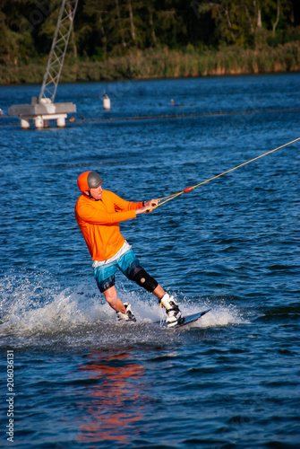Wakeboarder is training in a cable park