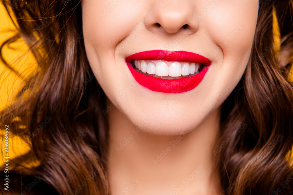 Close up half face portrait of toothy woman with beaming smile red lips white straight healthy teeth isolated on yellow background advertisement concept Close up half face portrait of toothy woman with beaming smile red lips white straight healthy teeth isolated on yellow background advertisement concept