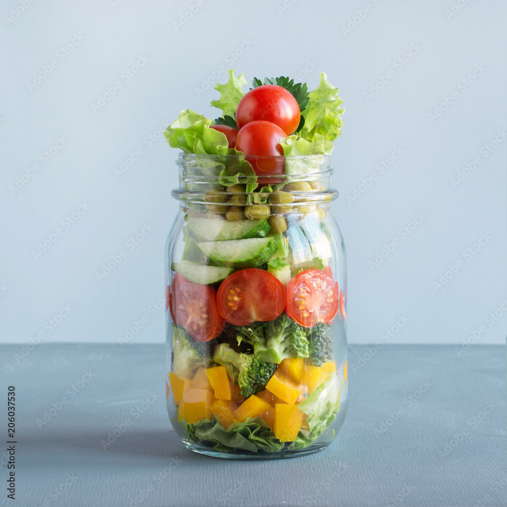 Vegetable salad in mason jar for eating in office. Square image. Vegetable salad in mason jar for eating in office. Square image.