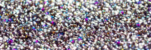 Glamorous light exude glass balls. Shine like brilliants. Beautiful shiny texture. Beads like stars on a velvet belt. Wealth of colors in the glass. Imitation of diamonds.
