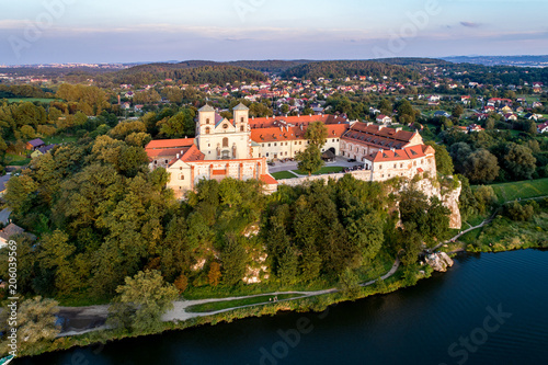 Benedictine monastery on the rocky cliff in Tyniec near Cracow, Poland, and Vistula River. Aerial view at sunset