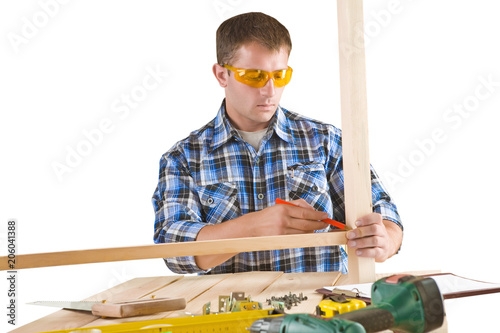 a young carpenter in work with wooden planks isolated photo