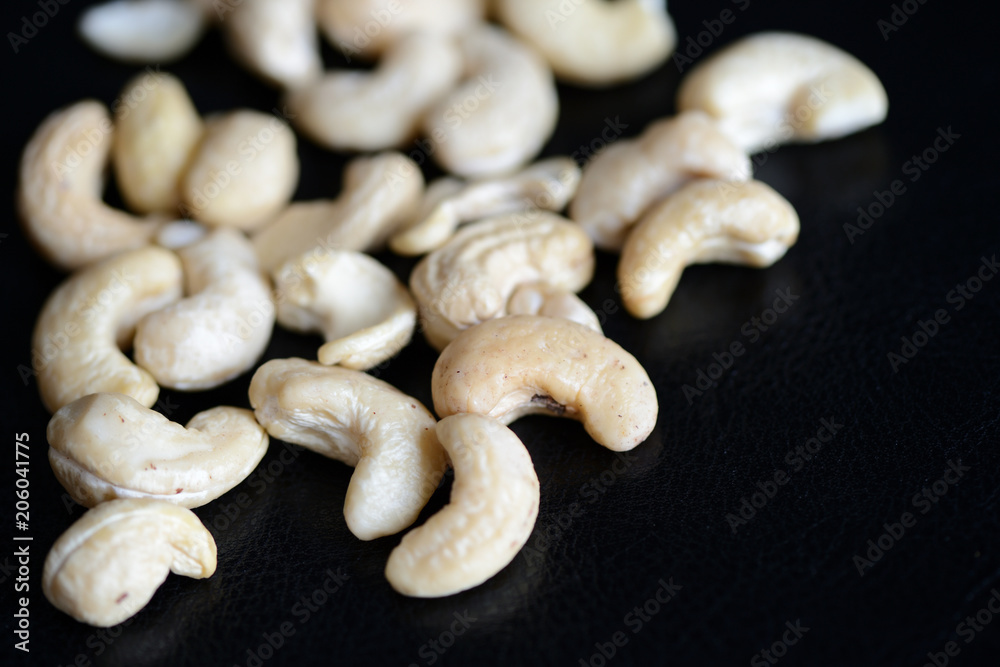 Cashew nuts on a dark background close up Cashew nuts on a dark background close up