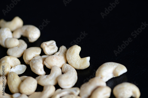 Cashew nuts on a dark background close up