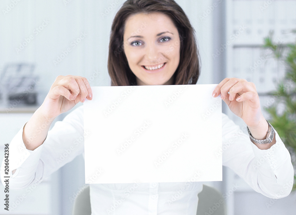 business woman showing blank sheet,sitting behind a Desk business woman showing blank sheet,sitting behind a Desk