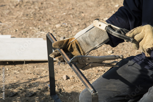 Close up Man welder working steel welds metal.