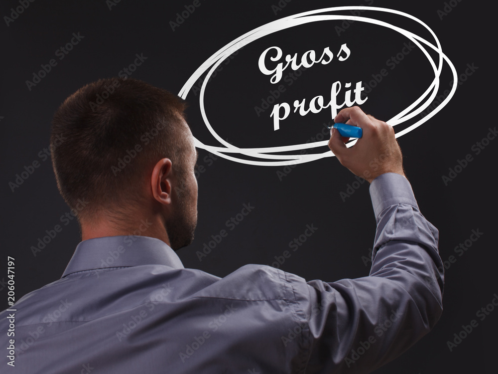 The concept of business, technology, the Internet and the network. Young businessman showing inscription: Gross profit The concept of business, technology, the Internet and the network. Young businessman showing inscription: Gross profit