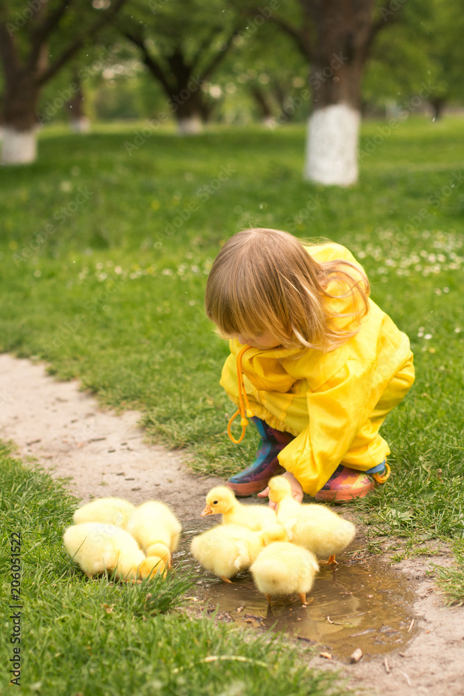 Little girl in cheap duck raincoat