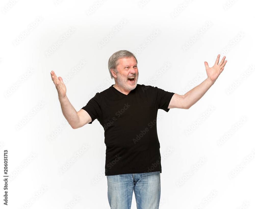 Closeup of senior man's body in empty black t-shirt isolated on white background. Mock up for disign concept Closeup of senior man's body in empty black t-shirt isolated on white background. Mock up for disign concept