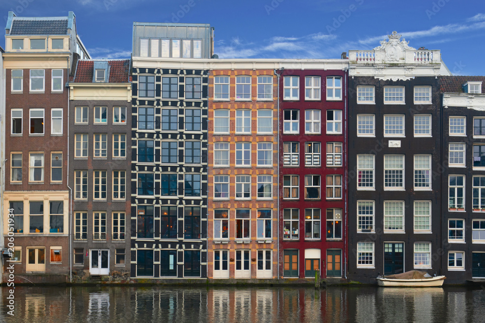 Beautiful facade of ancient buildings on a canal on the Amstel, Amsterdam.